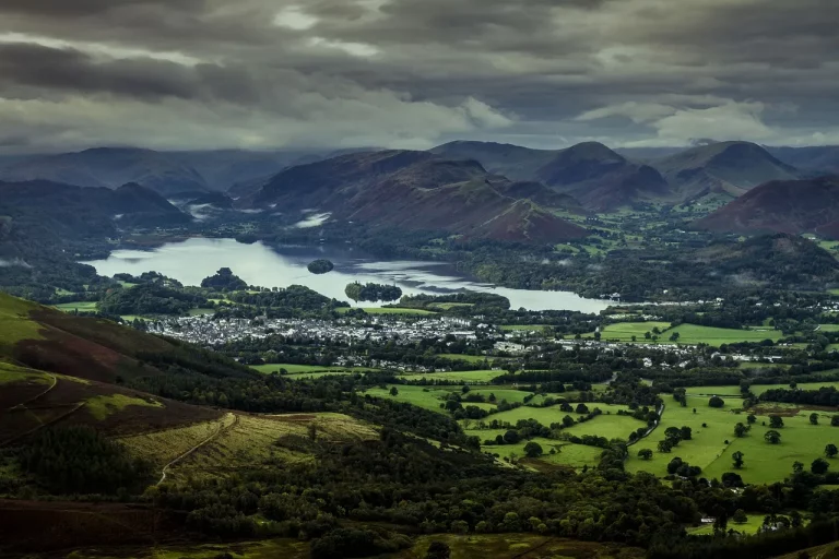 Rainy day in Keswick town centre with visitors exploring the Lake District despite the weather